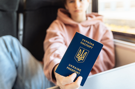 Teenager on train has Ukrainian passport in hand - b24 guide translate Ukrainian birth certificate.png
