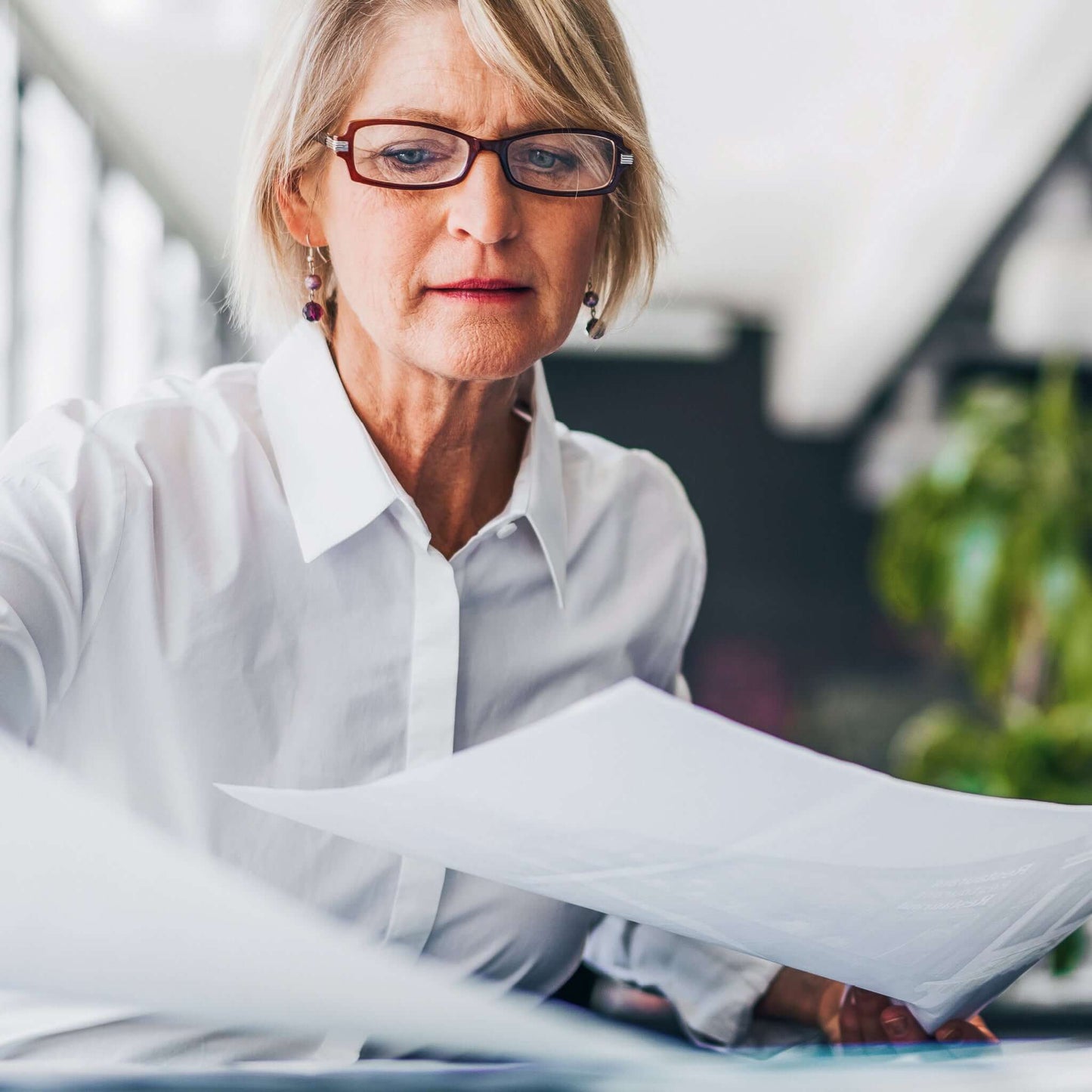 Have contract translated: A woman reads through a multi-page contract