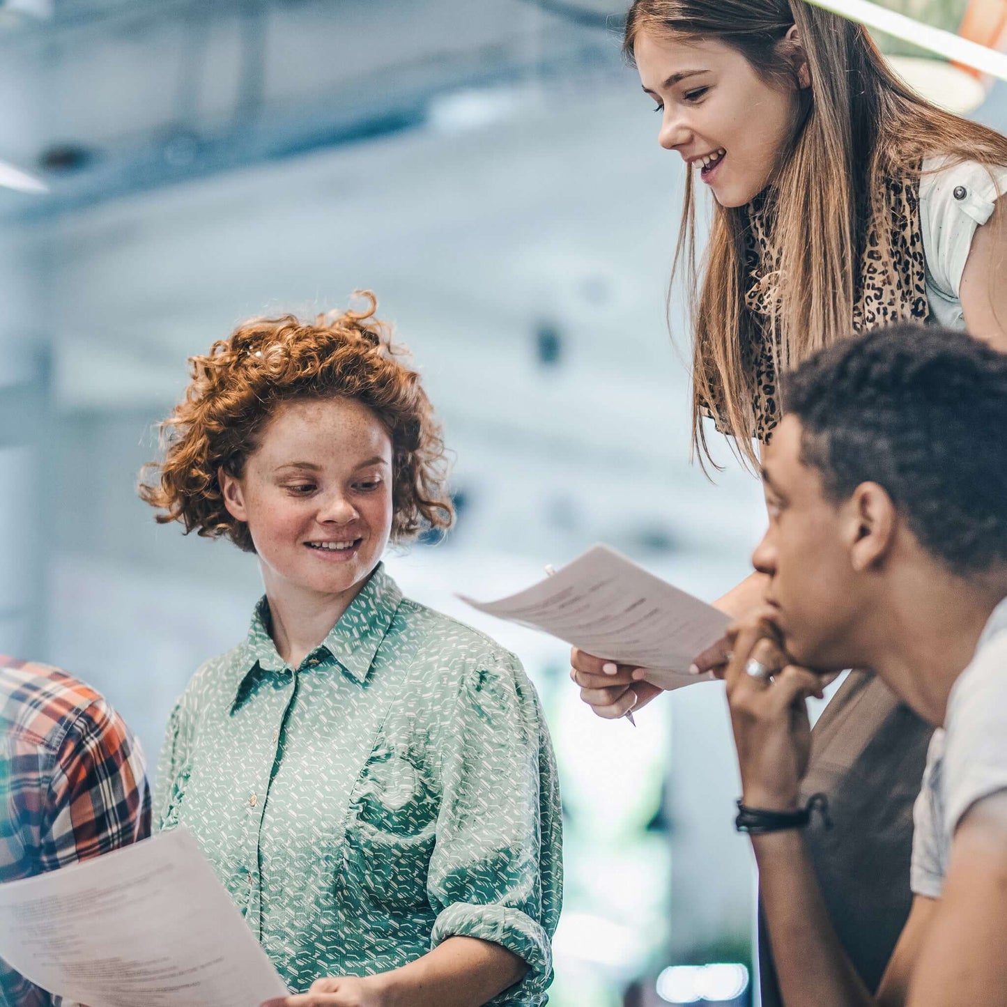 Have your high school diploma translated: Three students are happy about their school leaving certificates